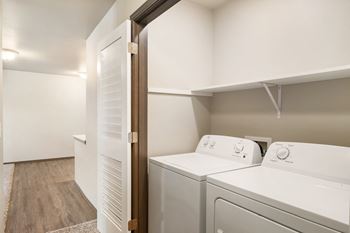 a washer and dryer in a laundry room with a door to the closet at Altitude, East Wenatchee, 98802